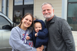 Neighbors smiling in front of the Manna Pantry in Yukon, Oklahoma.